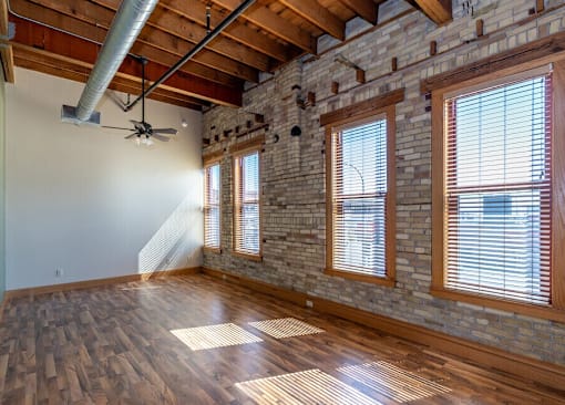 A room with wooden floors and a brick wall, Kassenborg Apartments, Moorhead, Minnesota, 56560