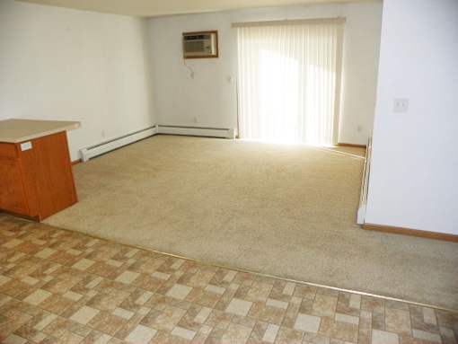 A room with a checkered floor and a window with curtains.