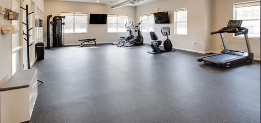 an empty gym with exercise equipment on the floor, Pinehurst Apartments, Baxter, 56425