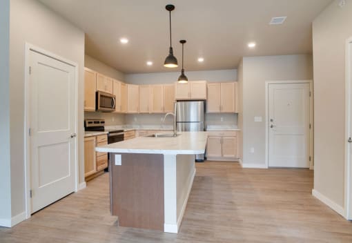 a large kitchen with an island in the middle, Pinehurst Apartments, Baxter, MN