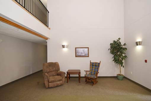 a living room with two chairs and a table and a potted plant Pinewood Estates, Zimmerman, MN