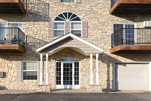 the front of a brick house with a white garage door Pinewood Estates, Zimmerman, 55398