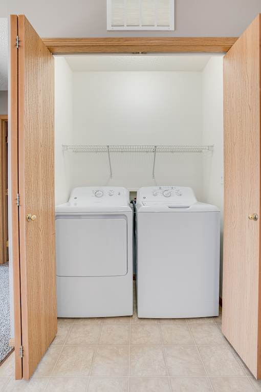 A small laundry room with a washer and dryer.