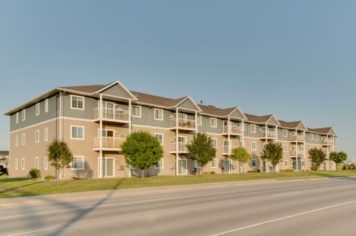 a street view of an apartment complex with a clear blue sky in the background at Waterstone Apartments, Moorhead, 56560