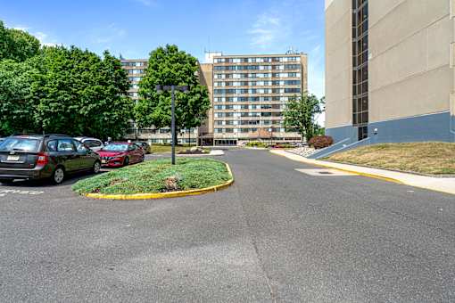 a parking lot with cars parked in front of a building