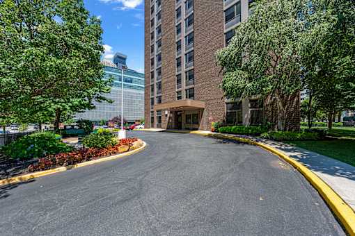 A curved driveway leads to a building entrance.
