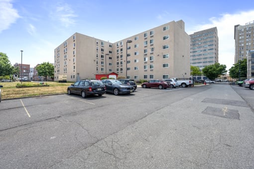 a parking lot with cars in front of a large building