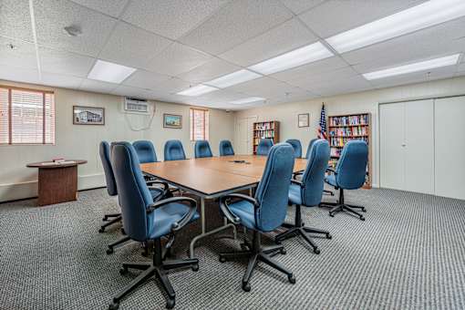 a conference room with a table and chairs