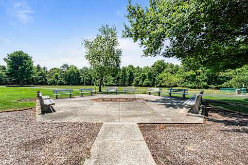 a park with benches and a square with a fountain