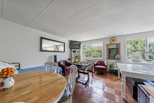 a dining room and living room with a table and chairs
