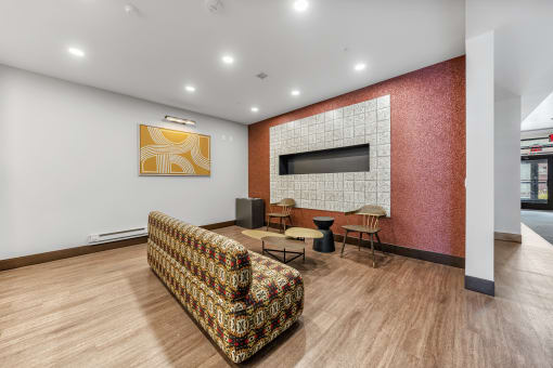 a living room with a couch and a television on a brick wall