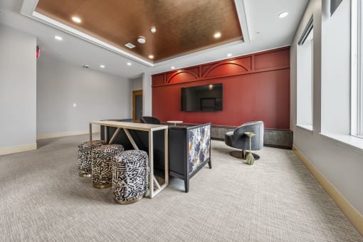 a conference room with a desk and a television in the corner