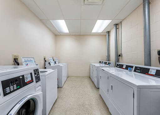 A row of washing machines in a laundromat.