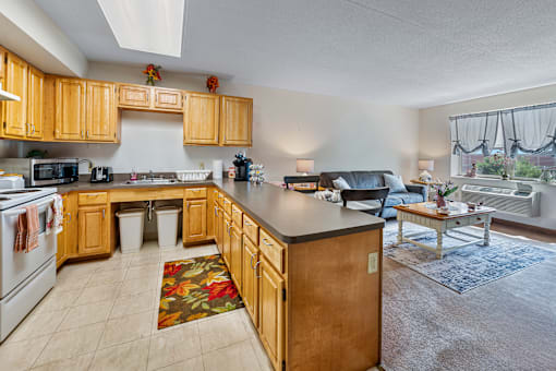 A kitchen with wooden cabinets and a black countertop.