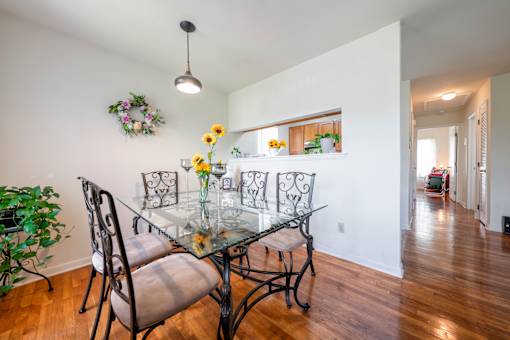 a dining room with a glass table and chairs