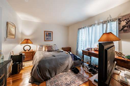 a bedroom with a bed and a tv