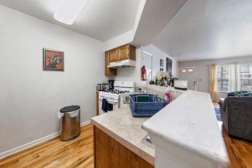 a kitchen with an island and a living room
