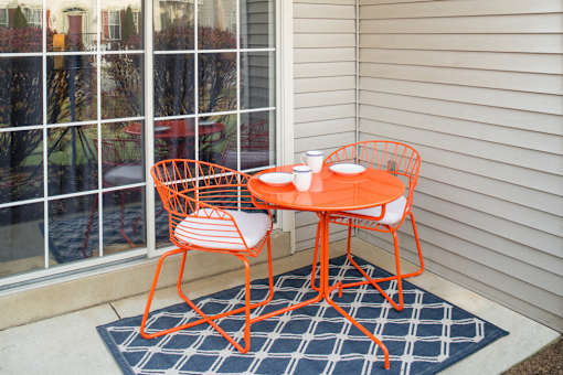 Private patio/balcony with a mini rug and dining table at Westridge Gardens