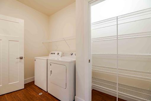 A white laundry room with a washer and dryer.
