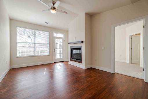 A room with a wood floor and a ceiling fan.