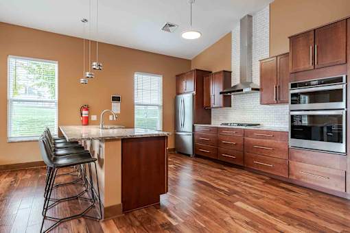 A kitchen with wooden floors and a large island.