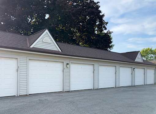A long row of white garage doors are closed.