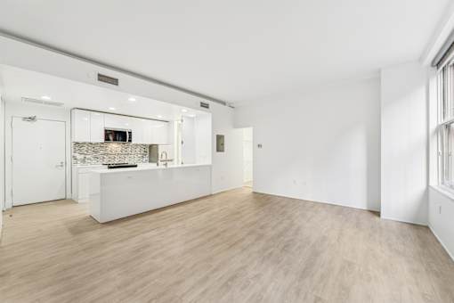 A spacious kitchen with a white countertop and a built-in oven.