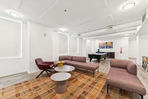 A room with a piano and a couch.
