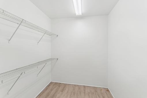 Empty room with a shelf and a light on the ceiling.