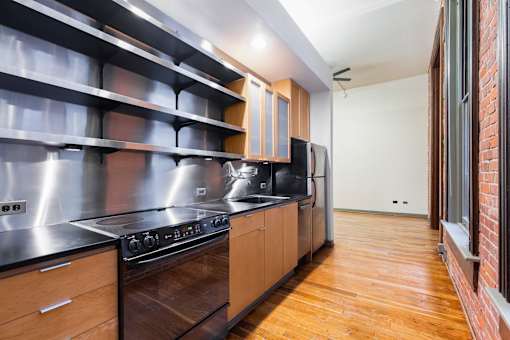 a kitchen with stainless steel appliances and wooden cabinets