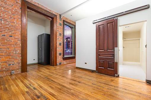 a living room with a wooden door and a door to a closet