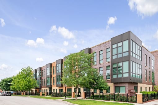 A modern building with a black fence in front.