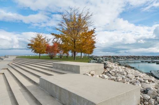 Image of concrete steps, with tree and Lake Michigan in the background at Eden Commons, Illinois, 60616