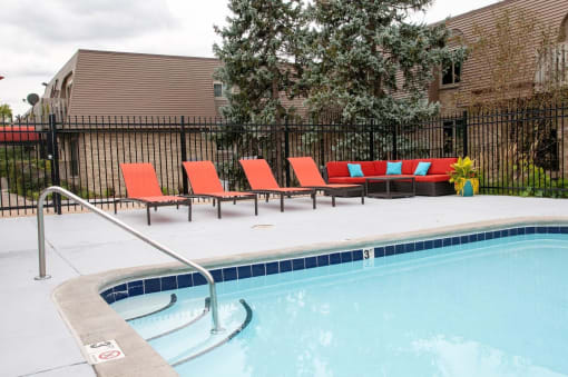 Private apartment pool deck and lounge area with outdoor furniture and controlled access to pool. 