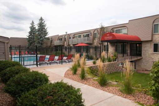 Front entrance of property near pool, pool deck, and grilling amenities