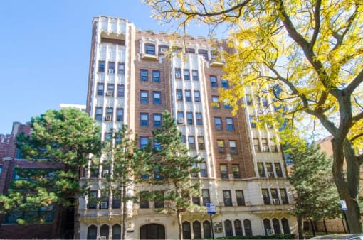 a tall building with trees in front of it