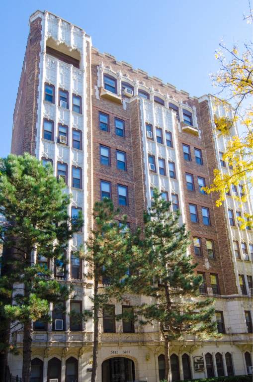 A tall building with many windows and balconies.