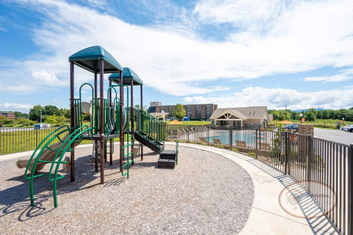a playground at a park with a swimming pool