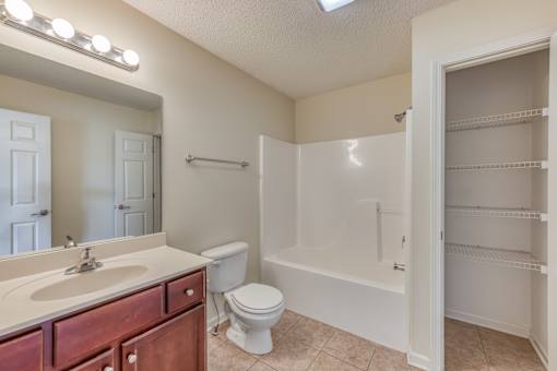A bathroom with a sink, toilet, and bathtub.