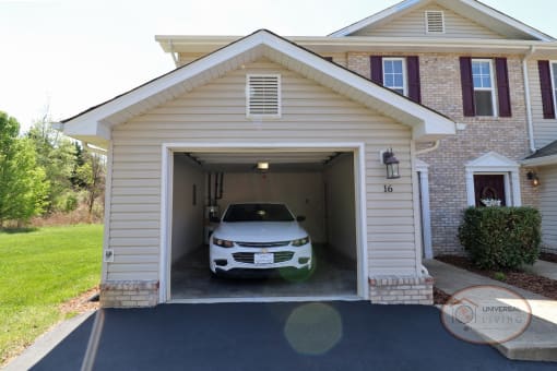 An attached garage with sedan inside.