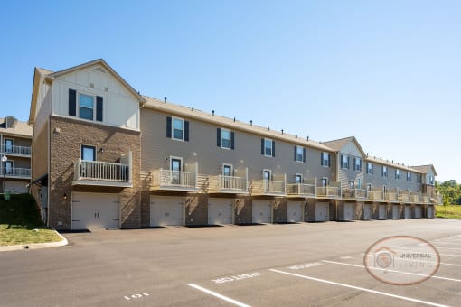 a large apartment building with balconies and a parking lot
