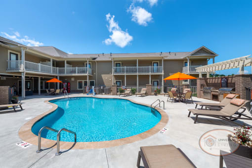Villas at Pigeon River Swimming pool with lounge chairs surrounded by apartments.