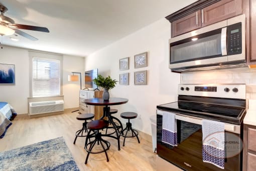 A studio apartment kitchen and dining area.
