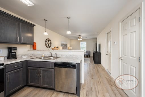 a kitchen with black cabinets and white counter tops and a sink