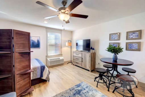 A studio apartment living area with flat screen TV.