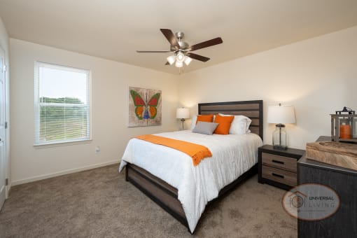 a bedroom with a bed and a ceiling fan