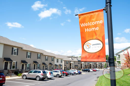 a welcome home banner in front of a hotel parking lot