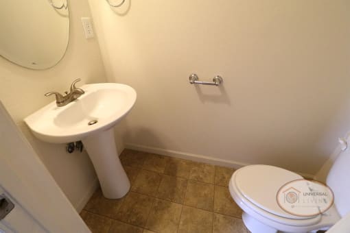 A half bathroom with sink and toilet.