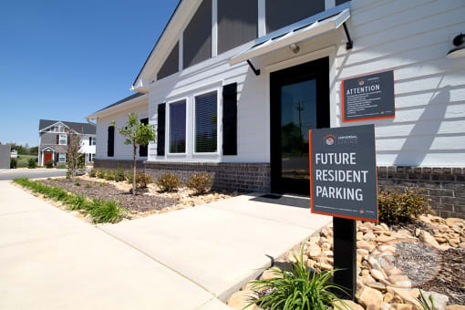 The clubhouse entrance with a sign in front of it that says "Future Resident Parking."