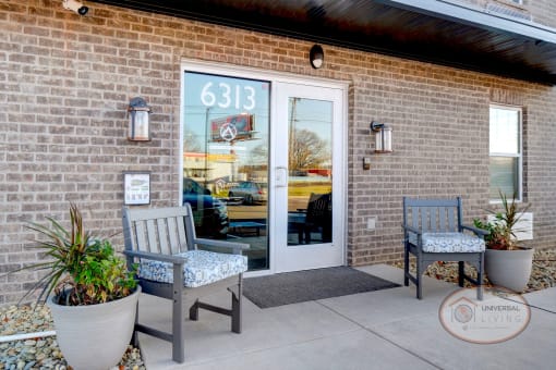 A glass door against a brick wall marks the entrance to Altitude @ 6313.